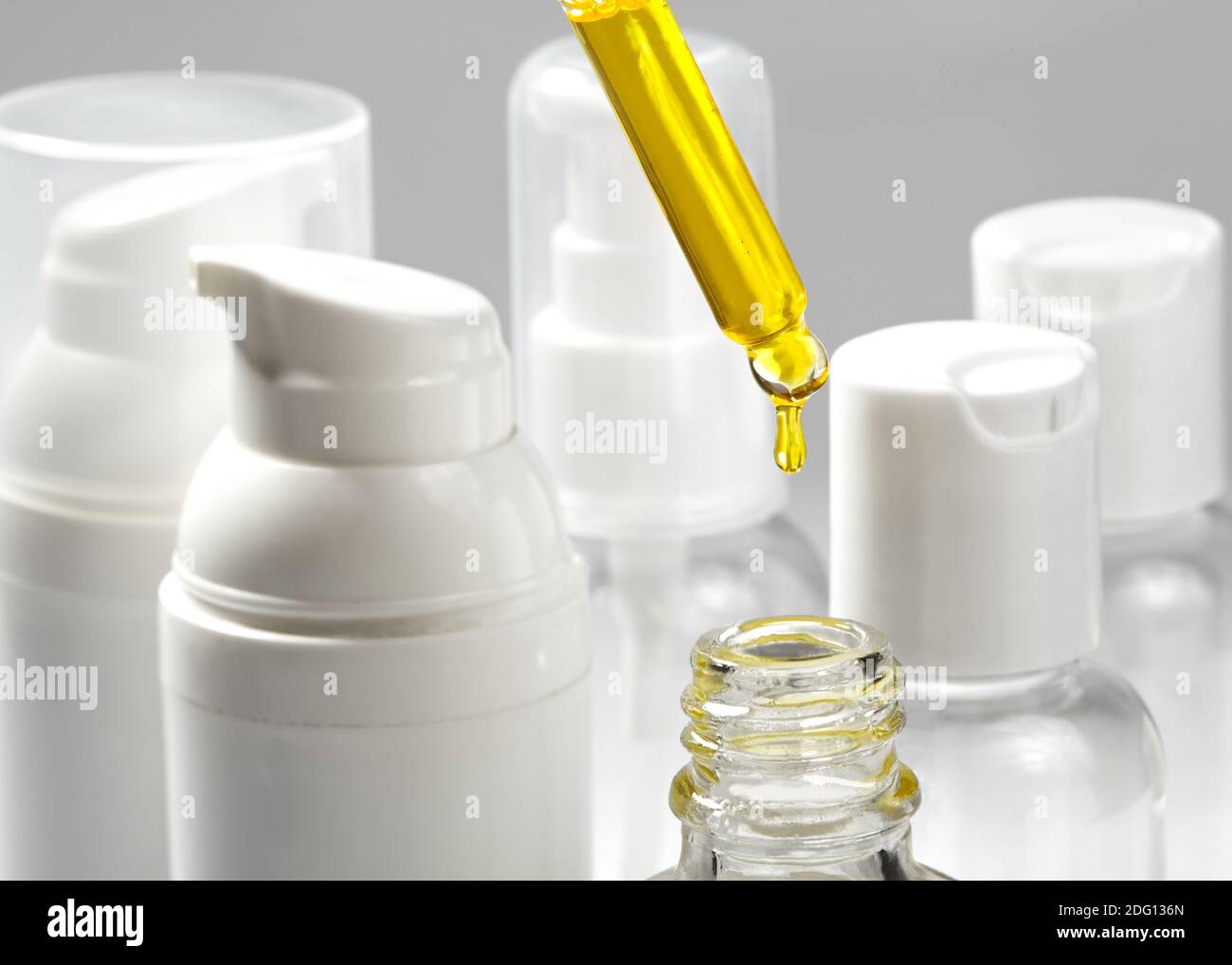White cosmetic bottles on white background with spa cosmetic oil. Wellness, spa and body care bottles collection. Beauty treatment Stock Photo
