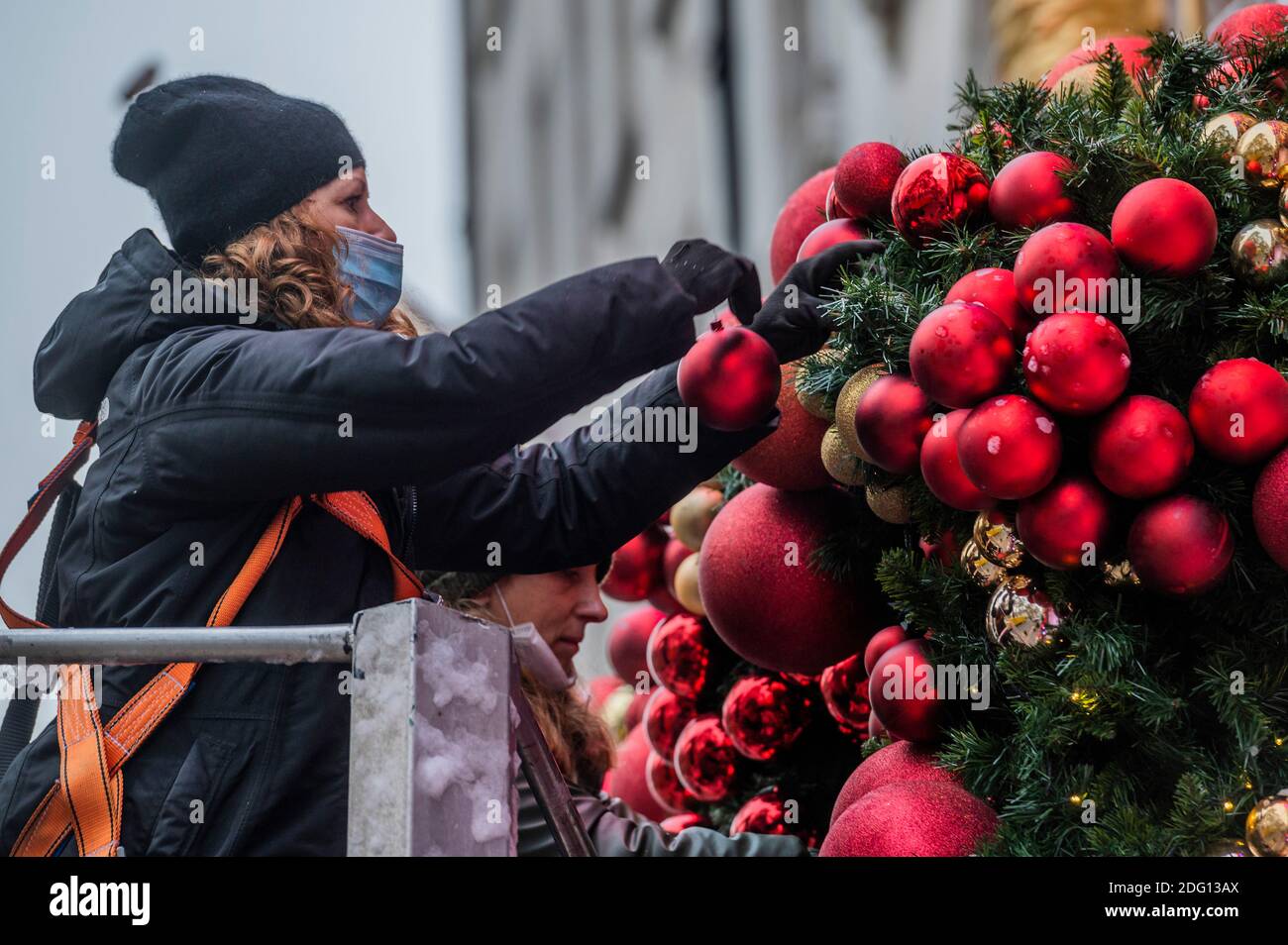 London, UK. 7th Dec, 2020. Final preparations are made to the Christmas decorations on the facade at Annabel's, Berkeley Square. Credit: Guy Bell/Alamy Live News Stock Photo