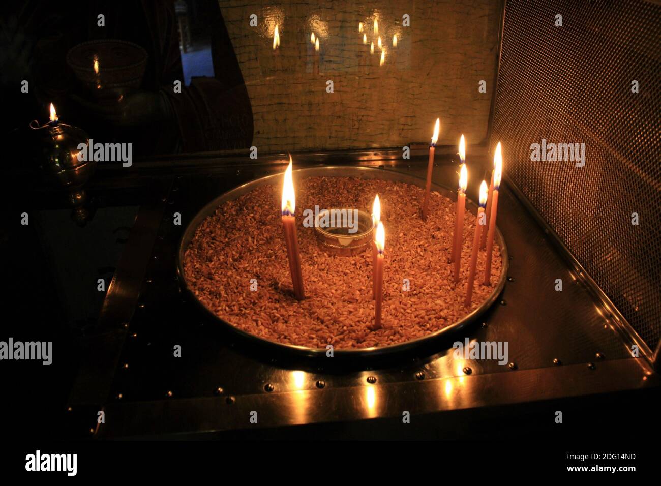 Lighting candles inside a Greek orthodox church Stock Photo Alamy