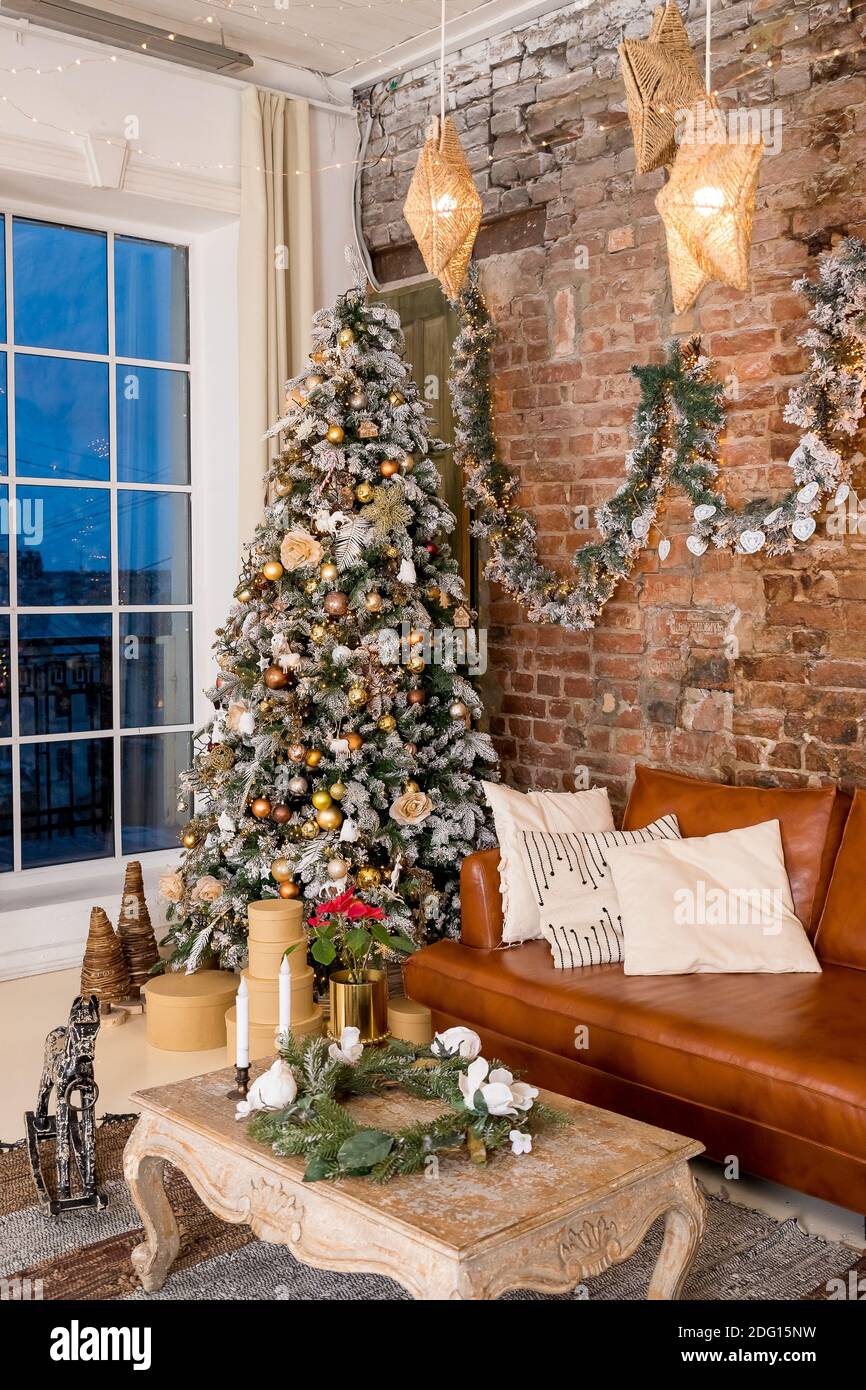 Winter home decor. Christmas tree in loft interior against brick ...