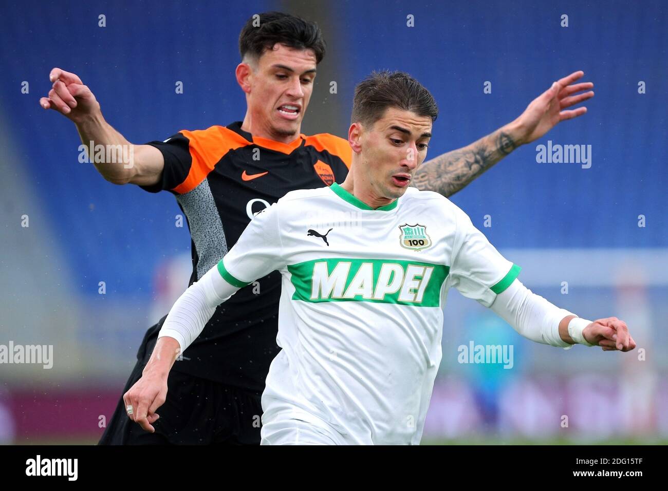Marash Kumbulla of Roma (L) fights for the ball with Filip Djuricic of Sassuolo (R) during the Italian championship Serie A / LM Stock Photo