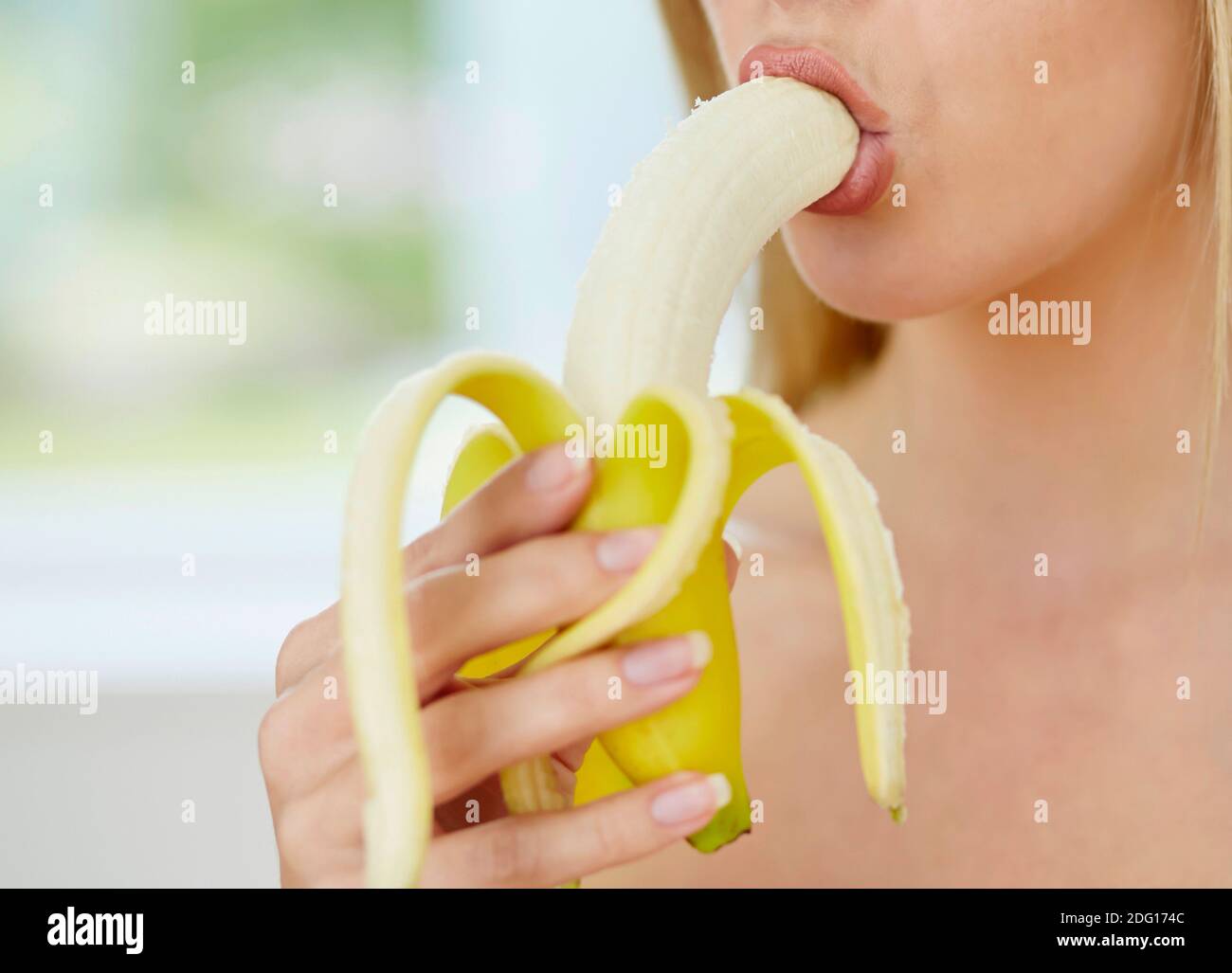 Image showcasing Woman licking banana Stock Photo - Alamy