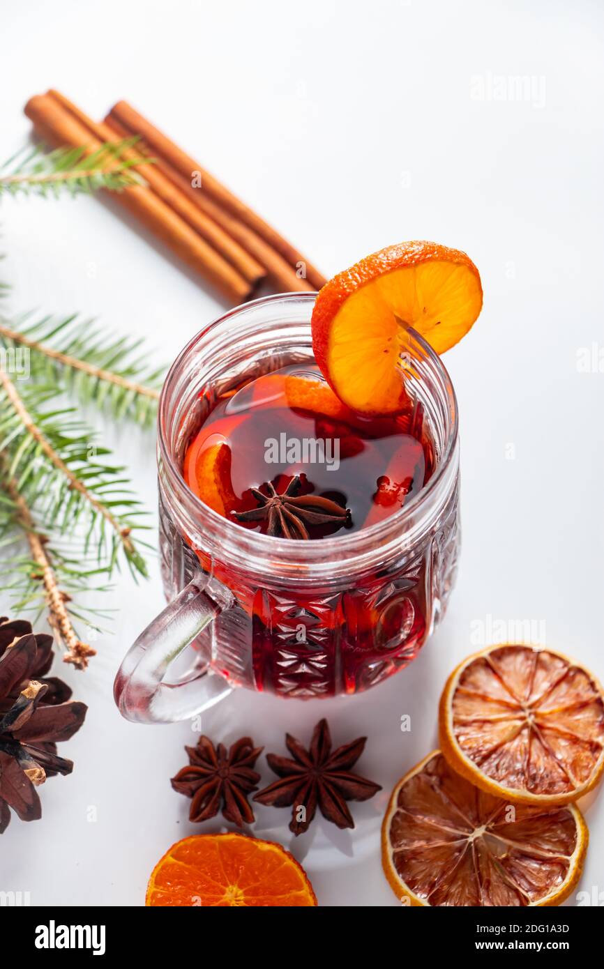 Winter warming mulled wine in glass cup on white background. Stock Photo