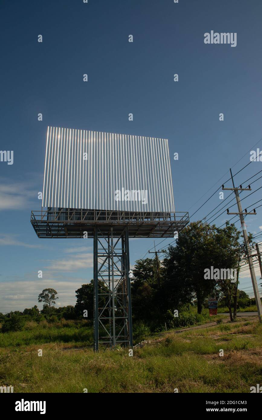 Blank billboard on the background of the road and blue sky. Stock Photo