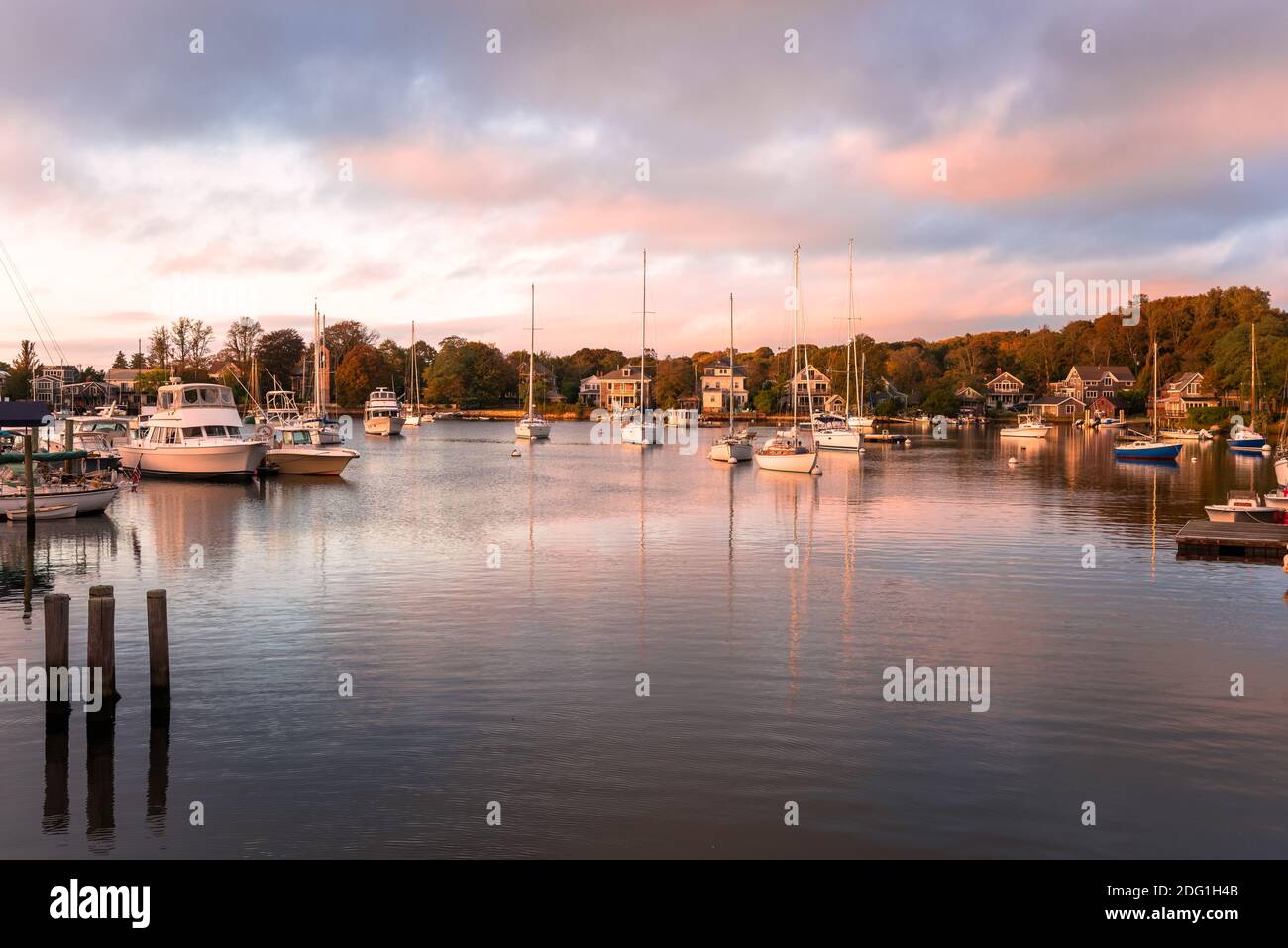 Harbour with anchored yacths at sunset in autumn Stock Photo