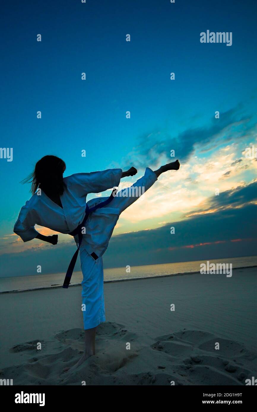 Karate on sunset beach Stock Photo