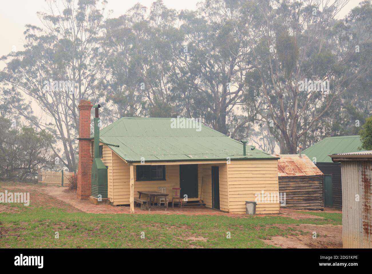 Old farm building in the Nyerimilang Heritage Park  shrouded in smoke during the bushfires in East Gippsland, Victoria, Australia Stock Photo