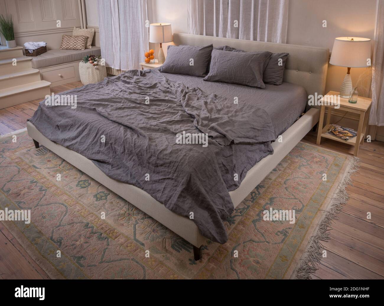 Wrinkled bed sheets in messy bedroom, USA Stock Photo