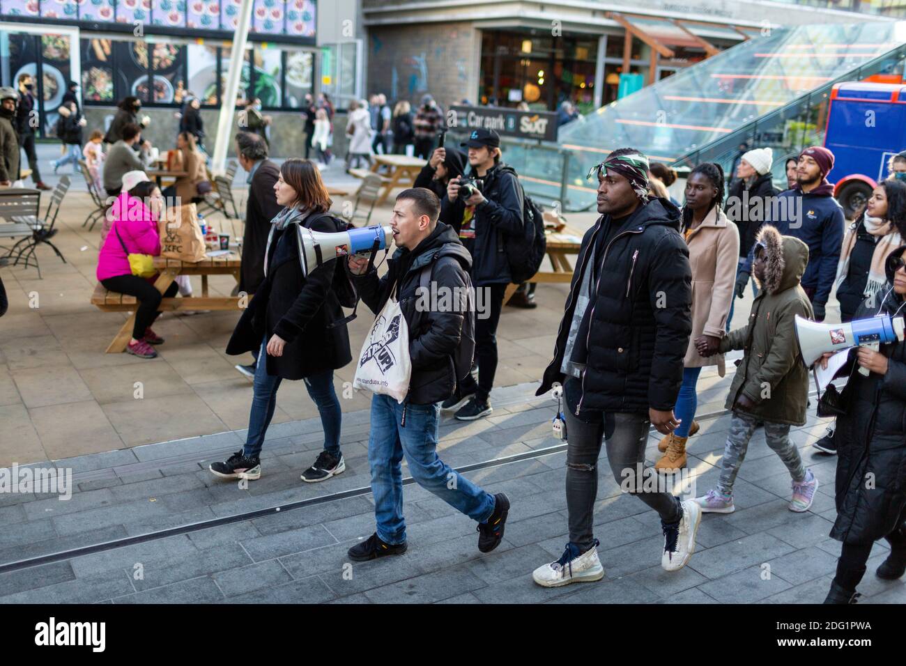 Anti-lockdown protest in Stratford, London, 5 December 2020. Protesters march through Westfield Stratford City Shopping Centre. Stock Photo