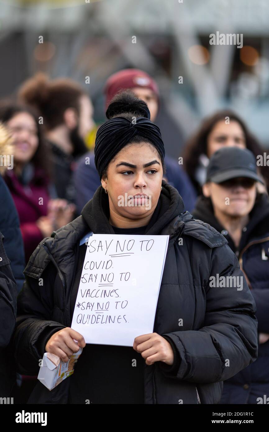 Anti-lockdown protest in Stratford, London, 5 December 2020. Portrait of a protester holding a placard. Stock Photo