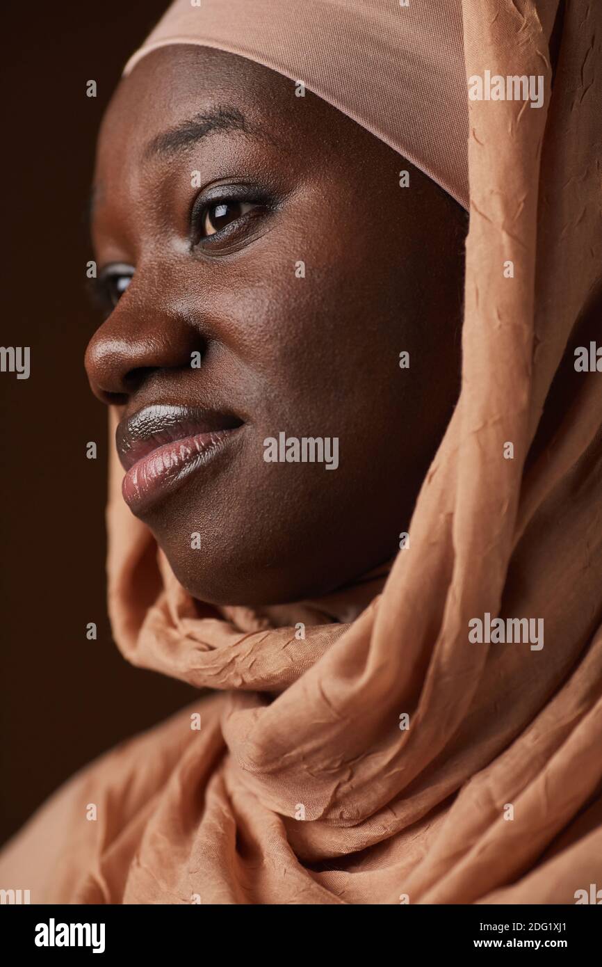 Vertical close up portrait of ethnic African-American woman wearing ...