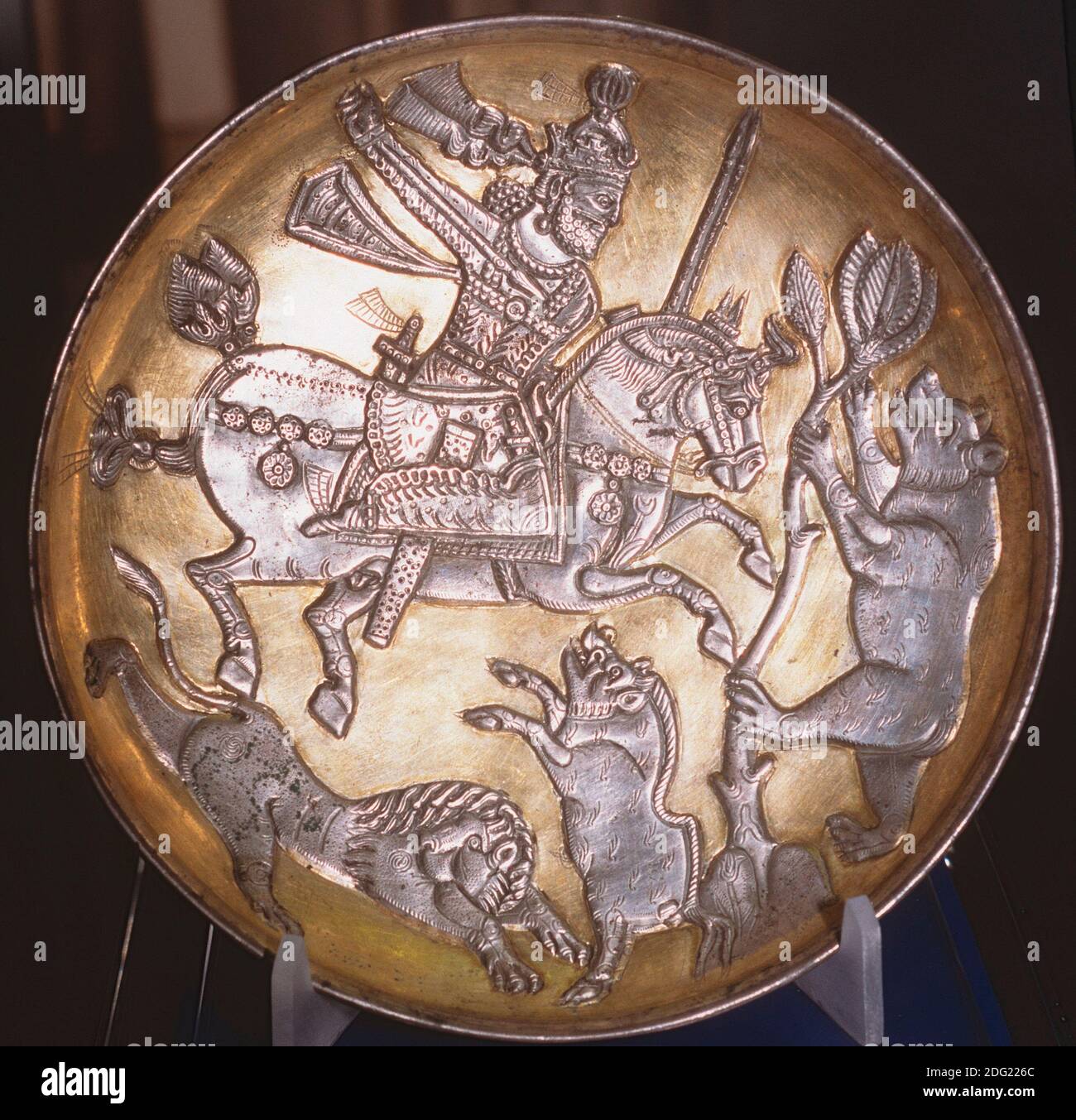 Sasanian gold-plated silver dish depicting the King hunting a lion, a boar and a bear, Tabriz Museum, Iran. Stock Photo