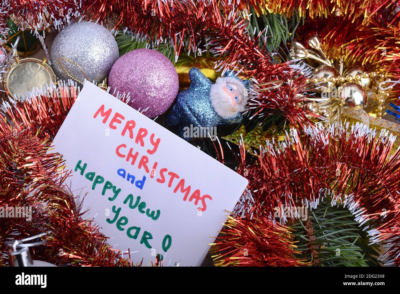 Merry Christmas and Happy New Year 2021 Holiday card. White paper and christmas greetings, ball set close up, christmas glitter confetti. Stock Photo