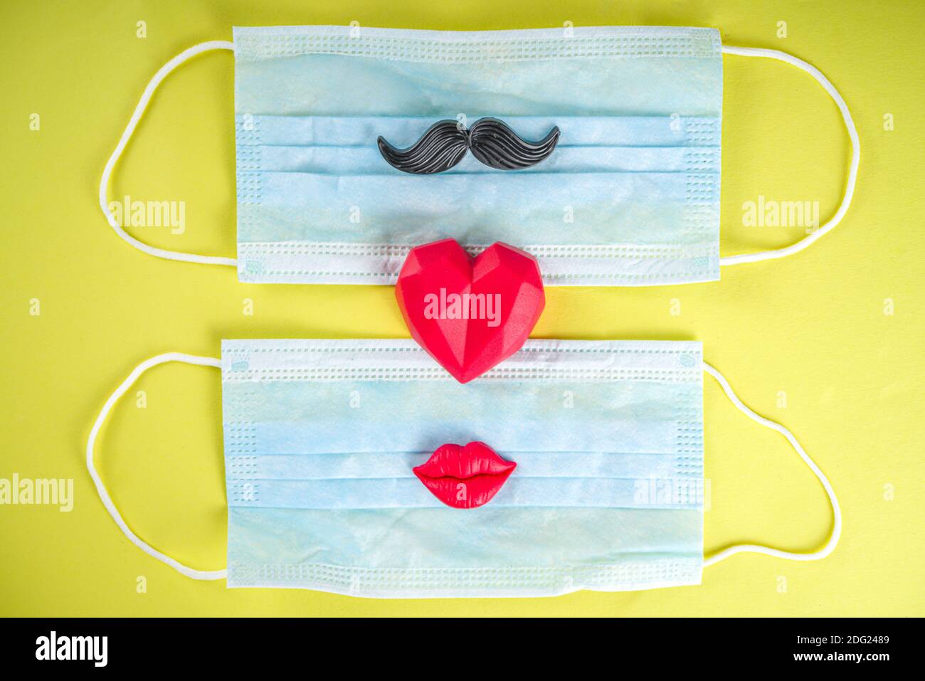 Red heart with medical mask, Valentine day or heath care, body renovation, protection concept, flatlay on bright yellow background. Complication of ca Stock Photo
