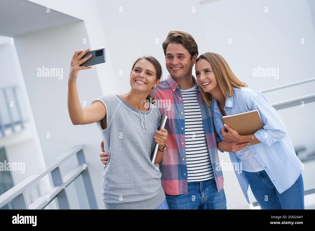 Group of students using smartphone in the campus Stock Photo