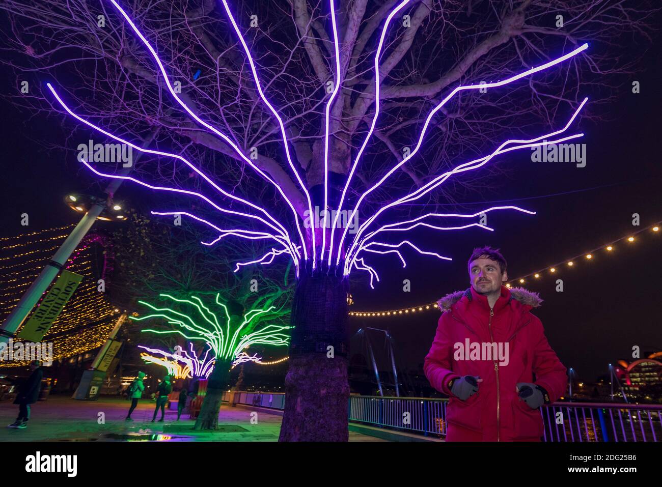 London, UK. 7 December 2020. Artist David Ogle in front of his work "Lumen", trees illuminated with glowing neon flex. Preview of “Winter Light” presented by Southbank Centre. Over 15 artworks and new illuminated commissions by a range of leading international artists are on display around the site’s buildings and the Riverside Walk until the end of February 2021. Credit: Stephen Chung / Alamy Live News Stock Photo