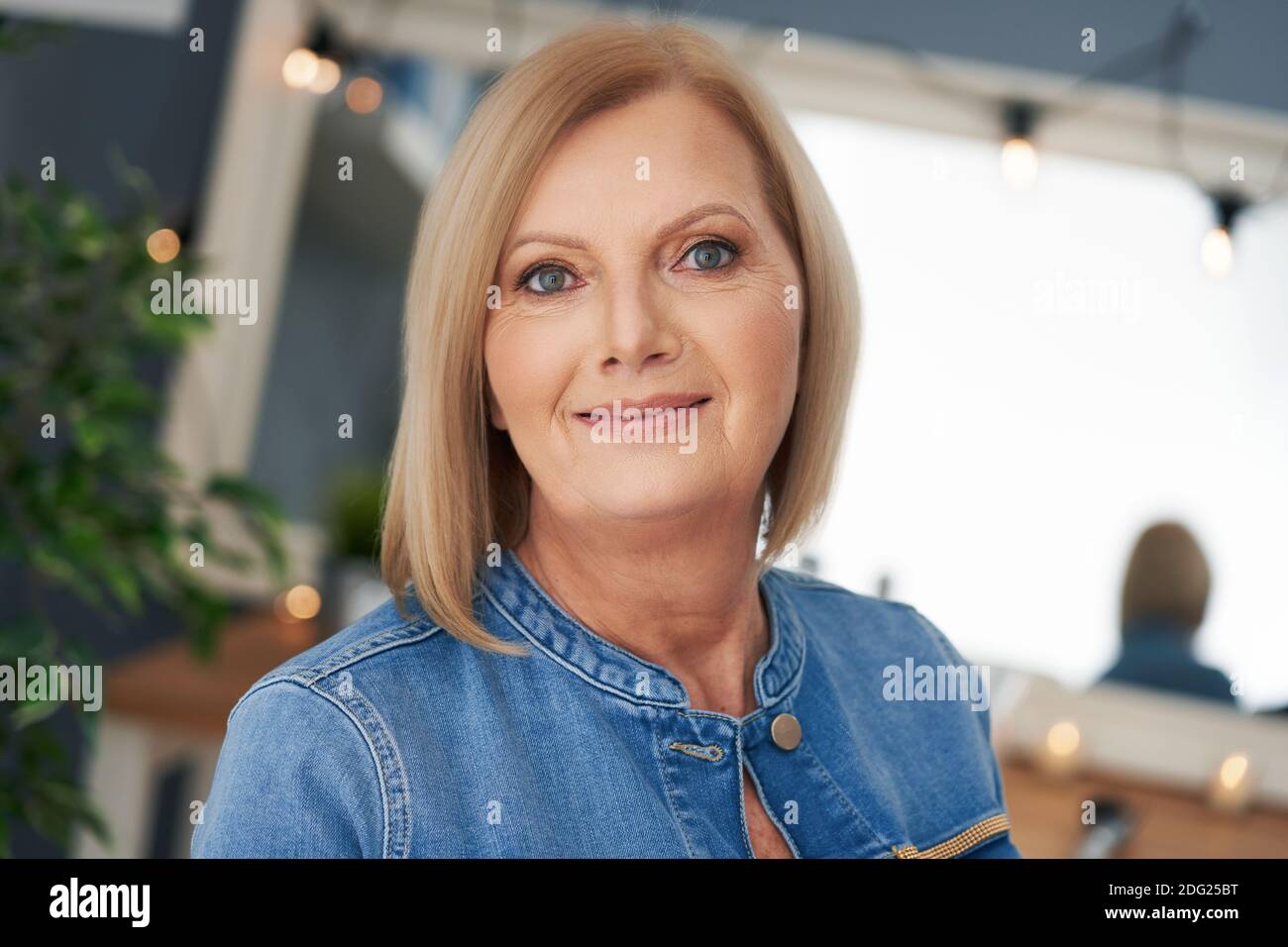 Senior woman posing in the bathroom Stock Photo