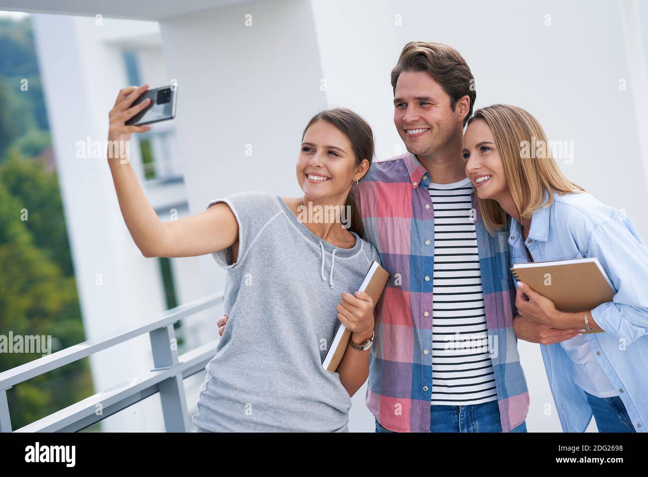 Group of students using smartphone in the campus Stock Photo