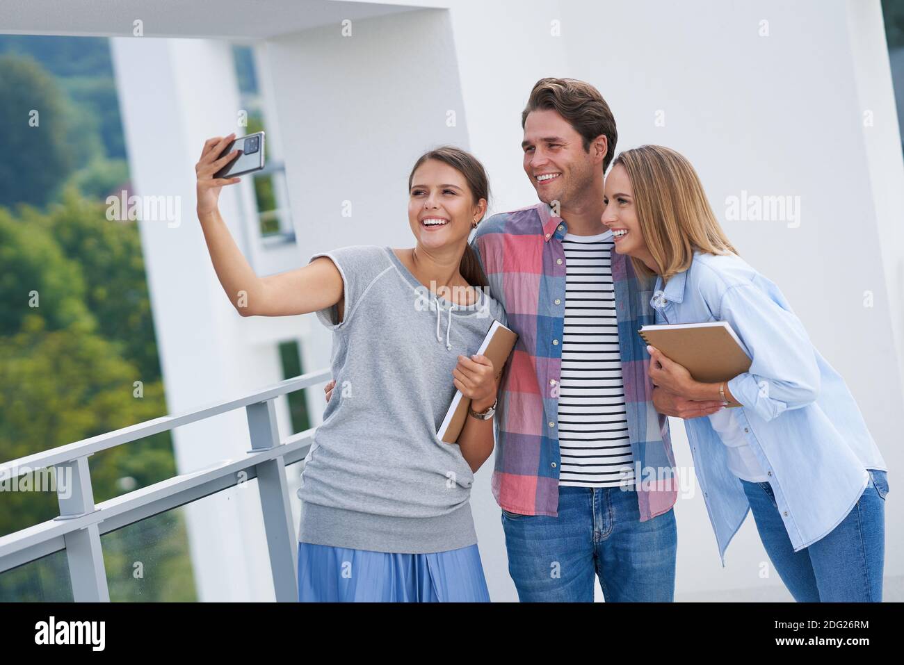 Group of students using smartphone in the campus Stock Photo