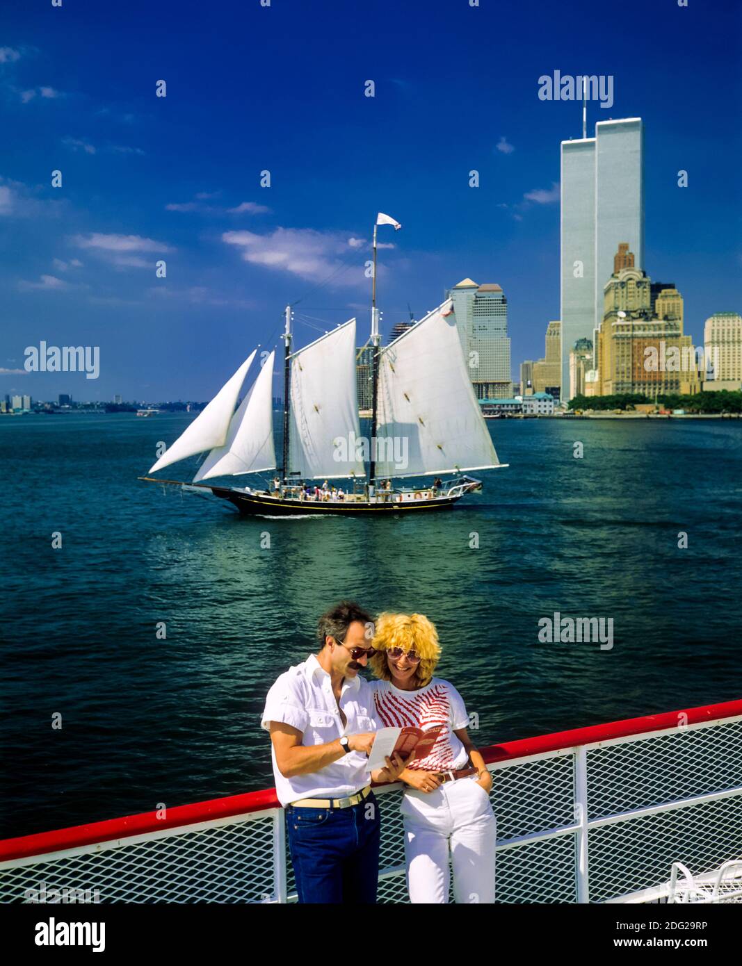 New York 1985, tourists couple, river cruise, Pioneer schooner sailboat, WTC World Trade Center twin towers, Manhattan, New York City, NY, NYC, USA, Stock Photo