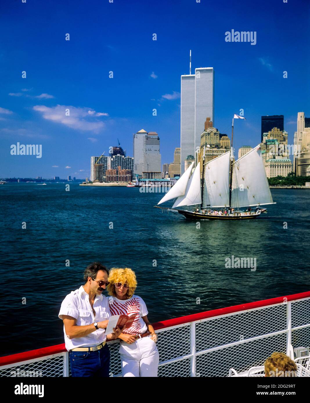 New York 1985, tourists couple, river cruise, Pioneer schooner sailboat, WTC World Trade Center twin towers, Manhattan, New York City, NY, NYC, USA, Stock Photo