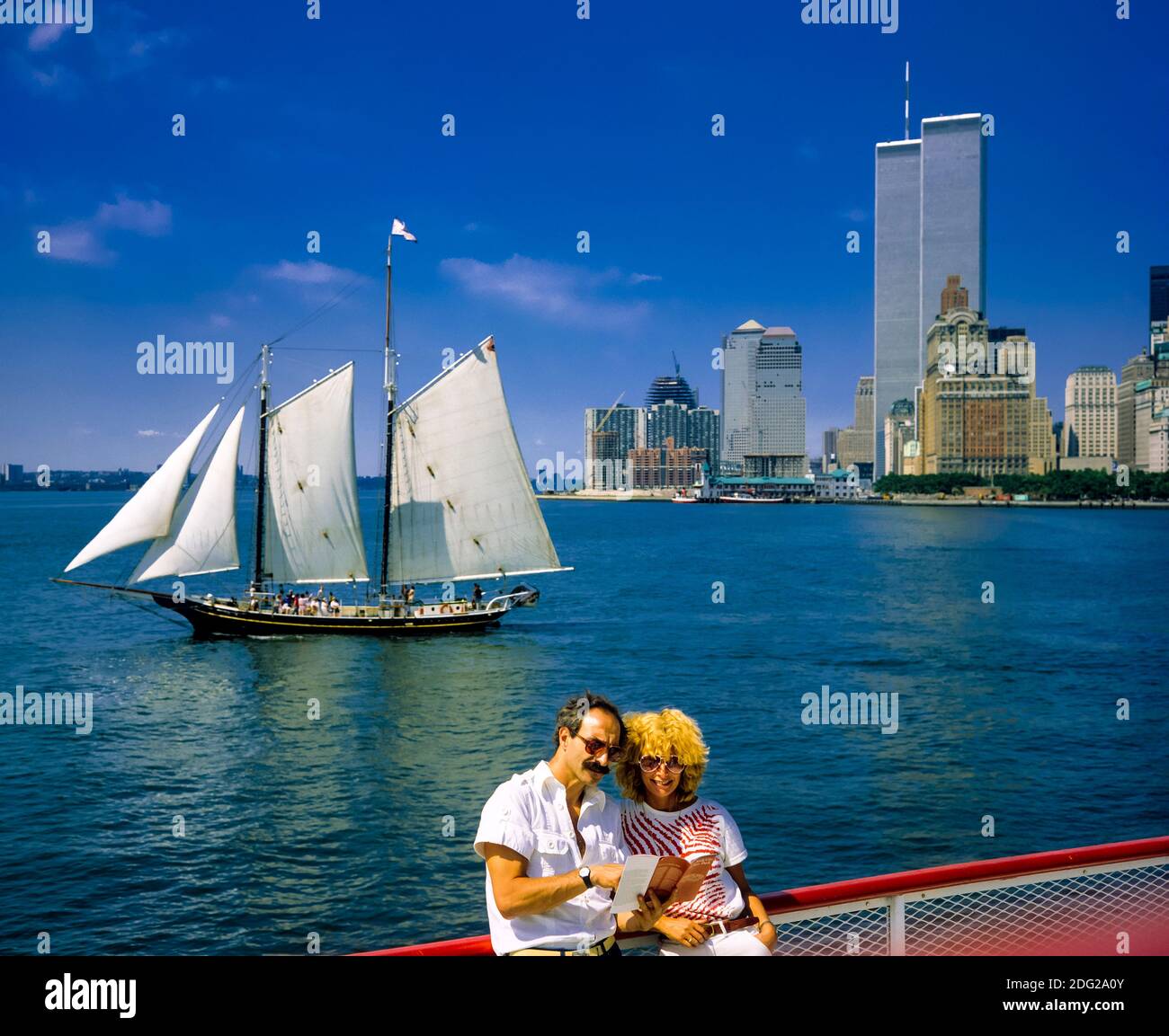 New York 1985, tourists couple, river cruise, Pioneer schooner sail boat, WTC World Trade Center twin towers, Manhattan, New York City, NY, NYC, USA, Stock Photo