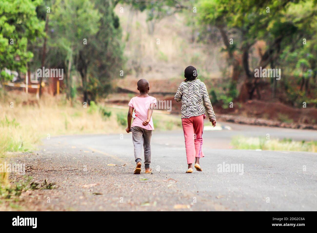 Two girls walk home in Mount Hampden just outside the capital city of