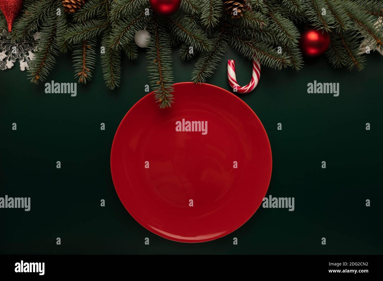 An empty red plate stands on the Christmas table. Stock Photo
