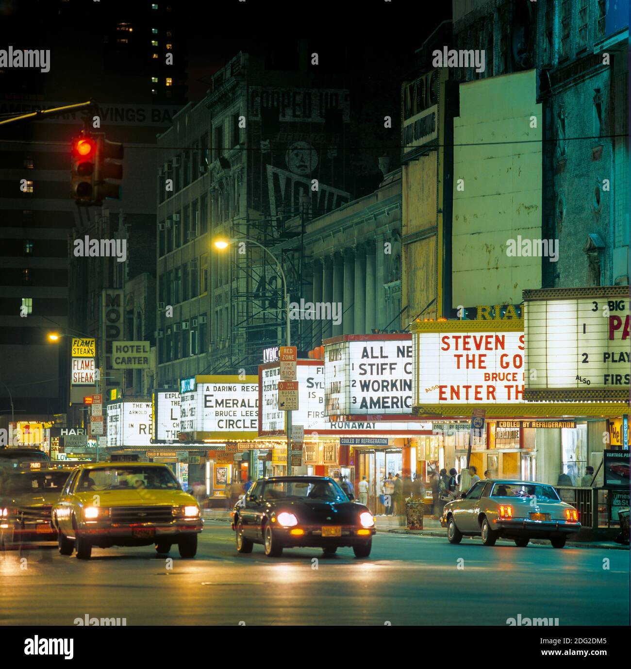 New York 1985, 42nd street, night, cars traffic, illuminated movie theatres marquees, midtown Manhattan, New York City, NY, NYC, USA, Stock Photo
