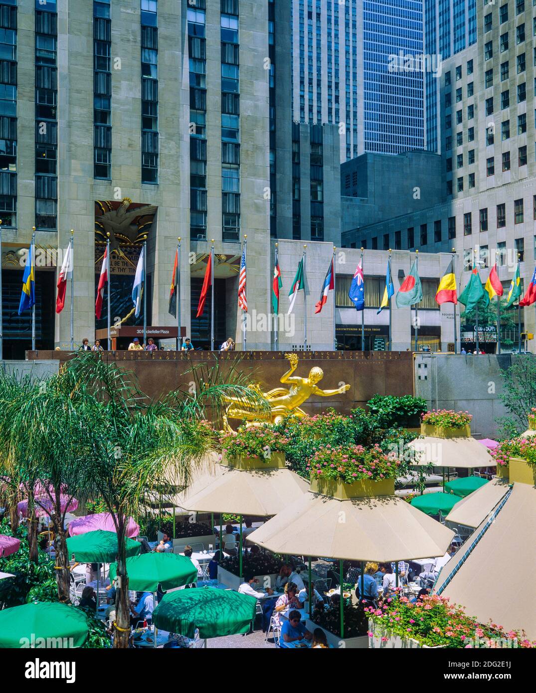 New York 1985, Rockefeller Center Plaza, Rink bar, restaurant, cafe terrace, Prometheus golden statue, flags from all countries, Manhattan, New york City, NY, NYC, USA Stock Photo