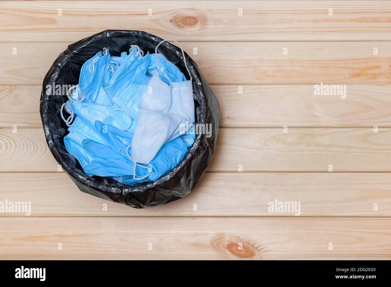 Trash Bin with Masks on Floor, Top View. Used Masks. Disposable Masks