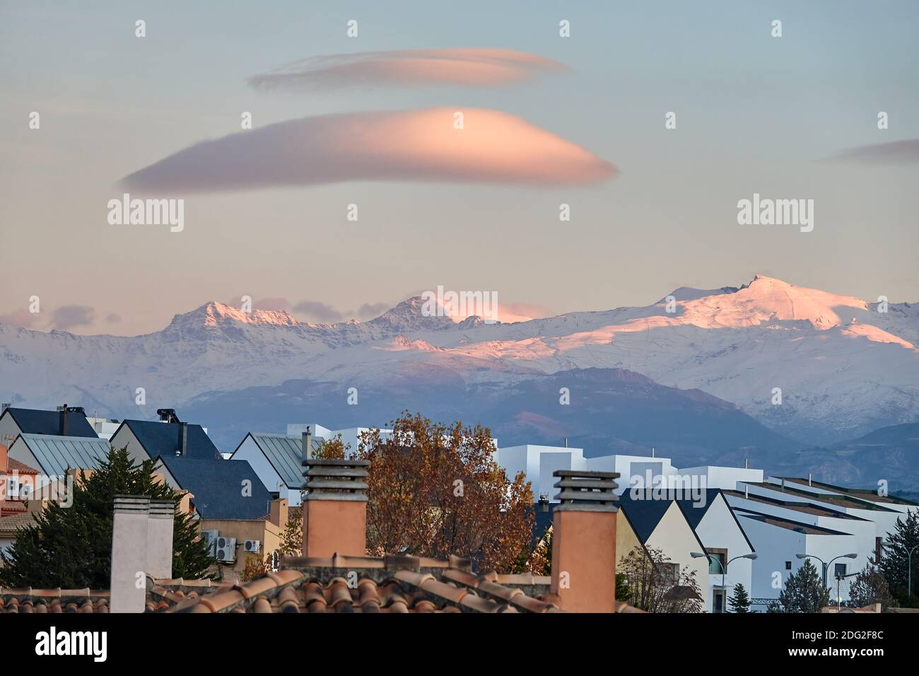 Large white lenticular clouds over Sierra Nevada (Spain) at sunset Stock Photo