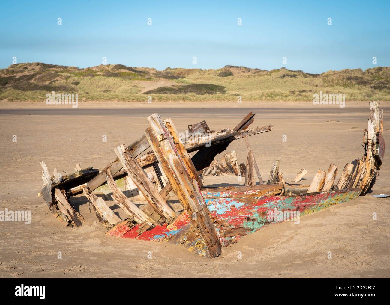 Skeletal remains of timber shipwreck on a sunny winter day at low tide on Crow Point beach at Braunton Burrows in Devon, South West England, Nov 2020 Stock Photo