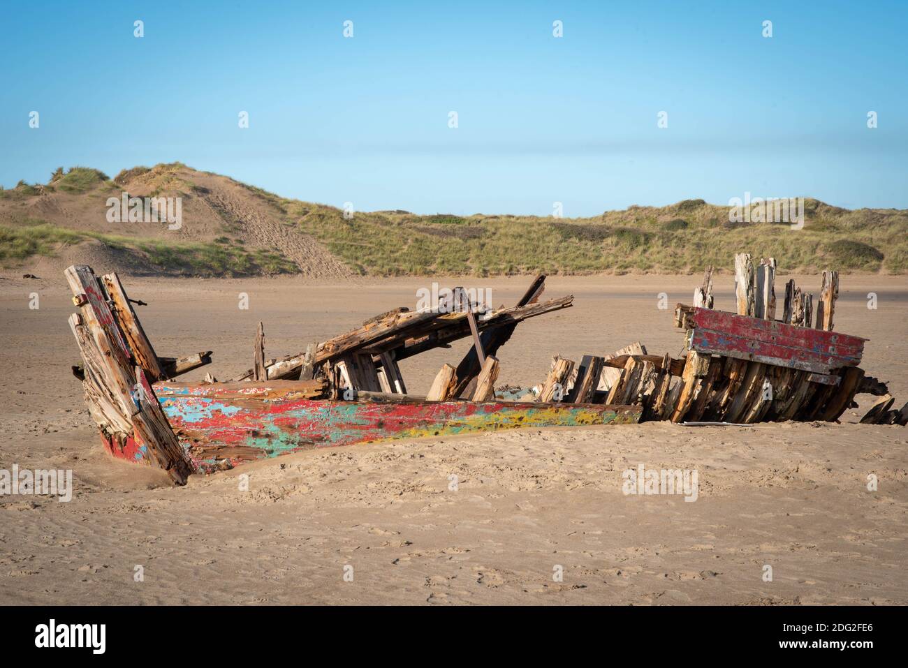Skeletal remains of timber shipwreck on a sunny winter day at low tide on Crow Point beach at Braunton Burrows in Devon, South West England, Nov 2020 Stock Photo