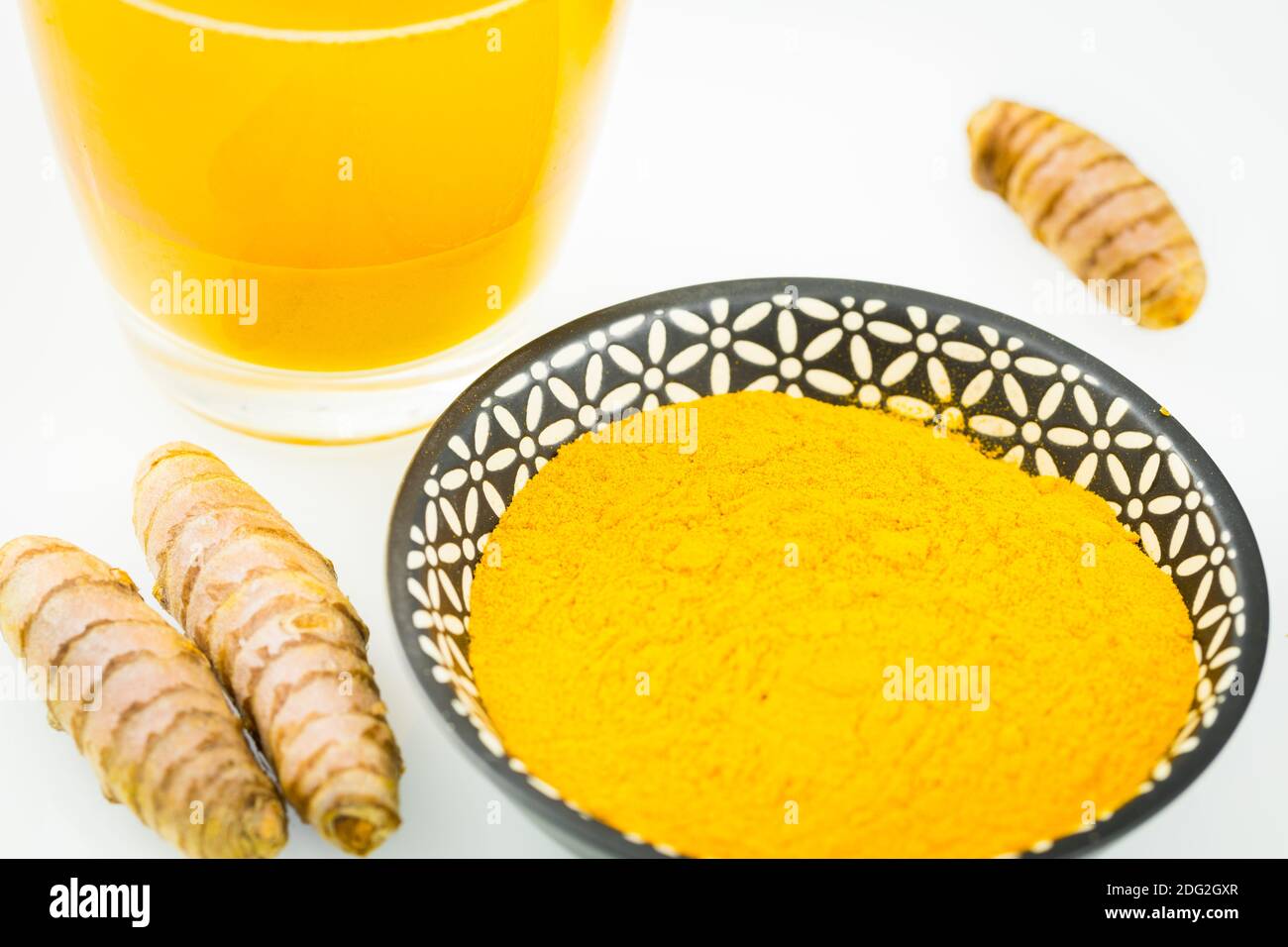 Turmeric. A healthy spice of yellow color, used in many cuisines of the world. Various variants, Powder, served in a glass of drinking water and as a Stock Photo