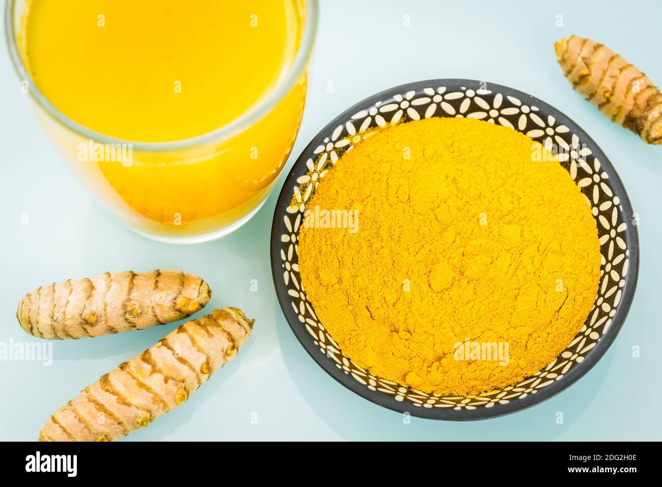 Turmeric. A healthy spice of yellow color, used in many cuisines of the world. Various variants, Powder, served in a glass of drinking water and as a Stock Photo