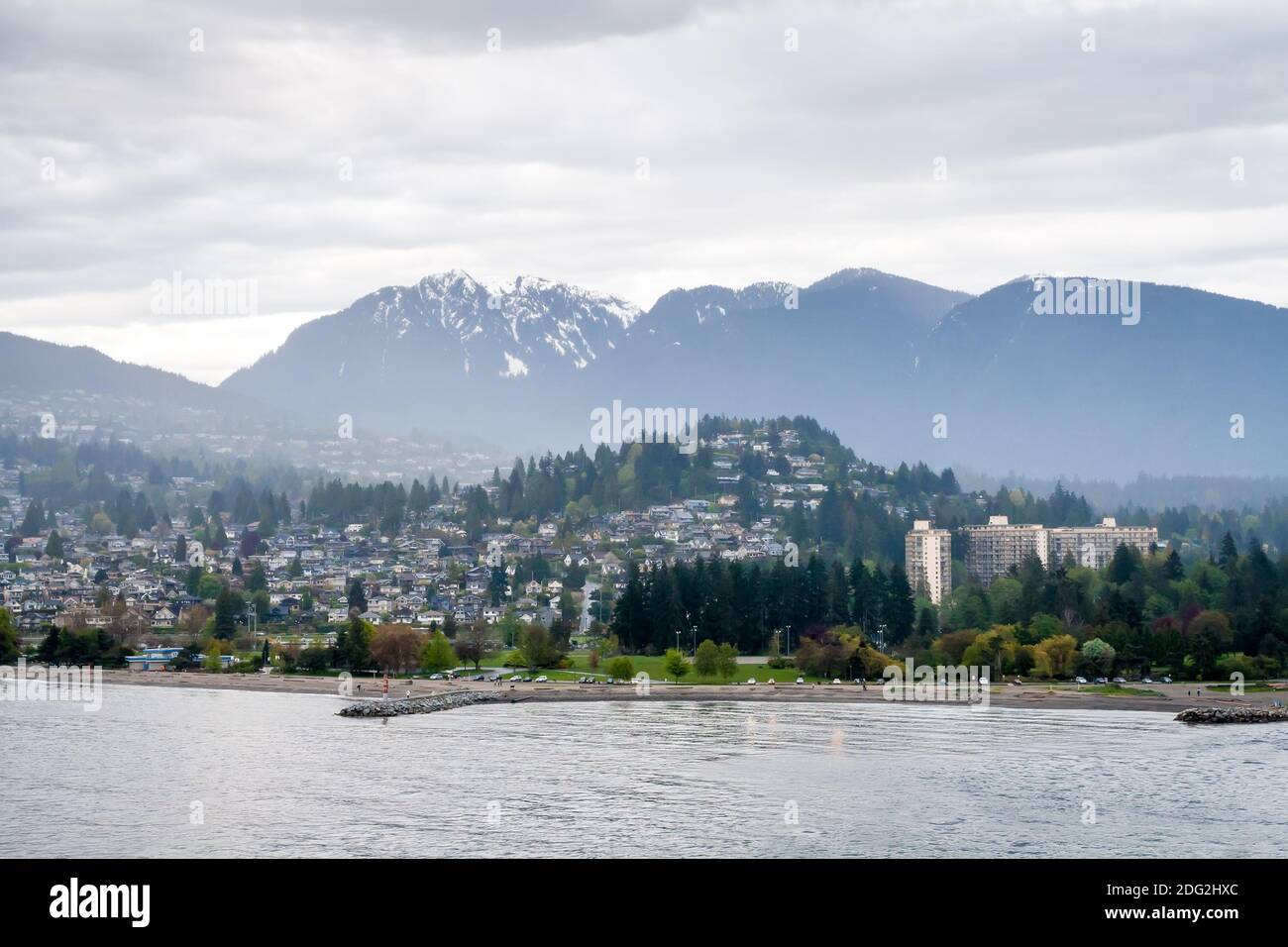 A view of Ambleside Beach and surrounding neighborhoods with mountains in the background in West Vancouver, British Columbia, Canada Stock Photo