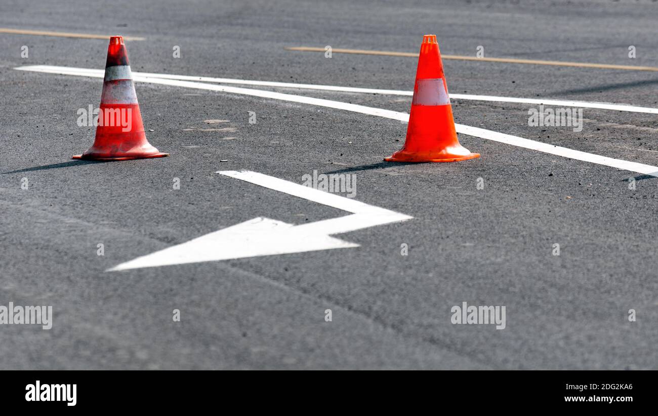 Road block with white arrow showing the alternate way Stock Photo