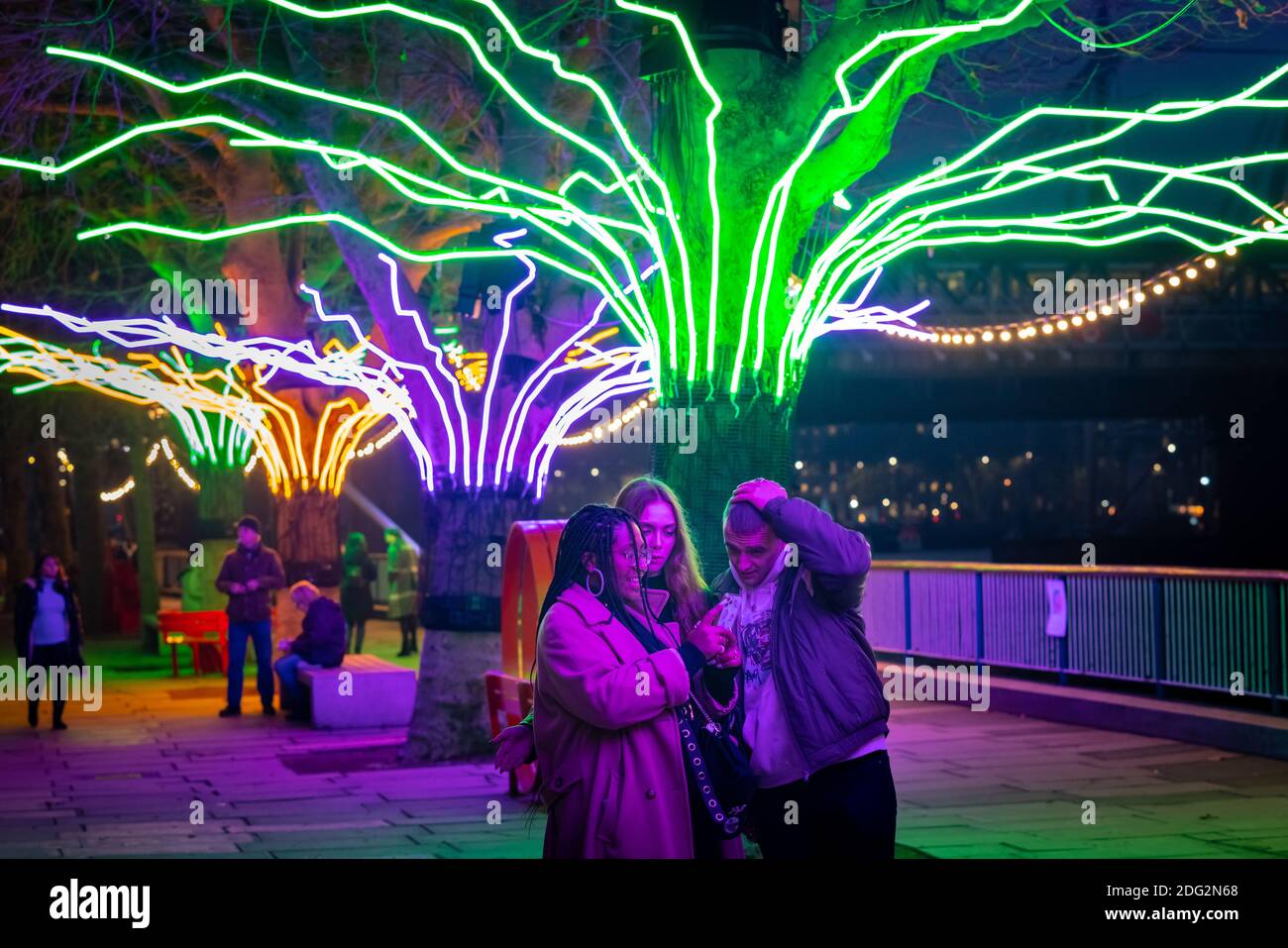London, UK. 7th Dec 2020. “Winter Light” at Southbank Centre. "Lumen", trees illuminated with glowing neon flex by artist David Ogle. Over 15 artworks and new illuminated commissions by a range of leading international artists feature during "Winter Light" located around the Southbank buildings and Riverside Walk until the end of February 2021. Credit: Guy Corbishley/Alamy Live News Stock Photo