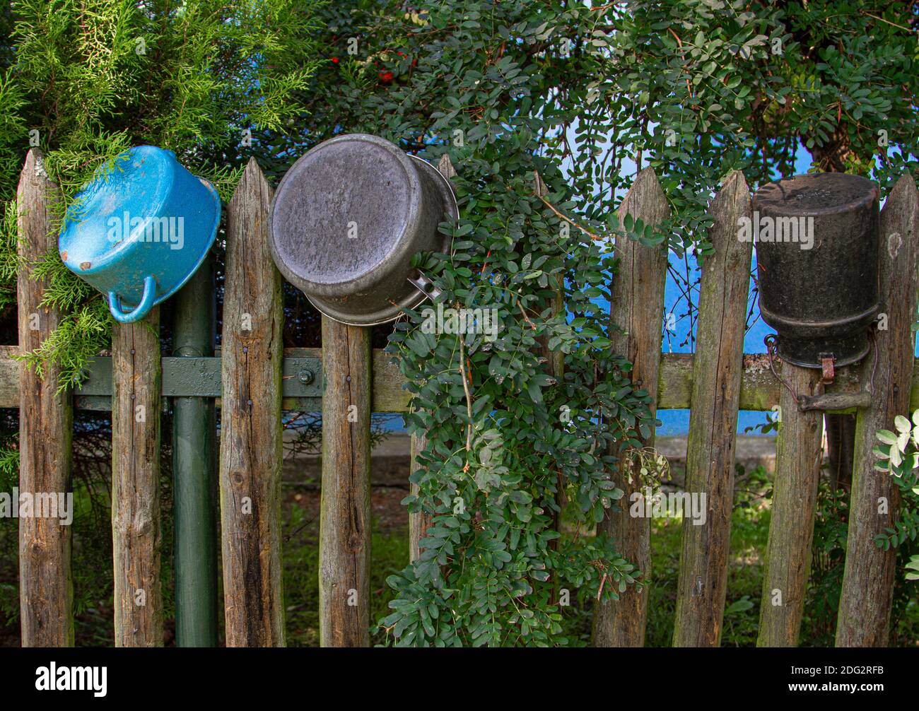 Picket fence decorated with pots in front of an old house Stock Photo