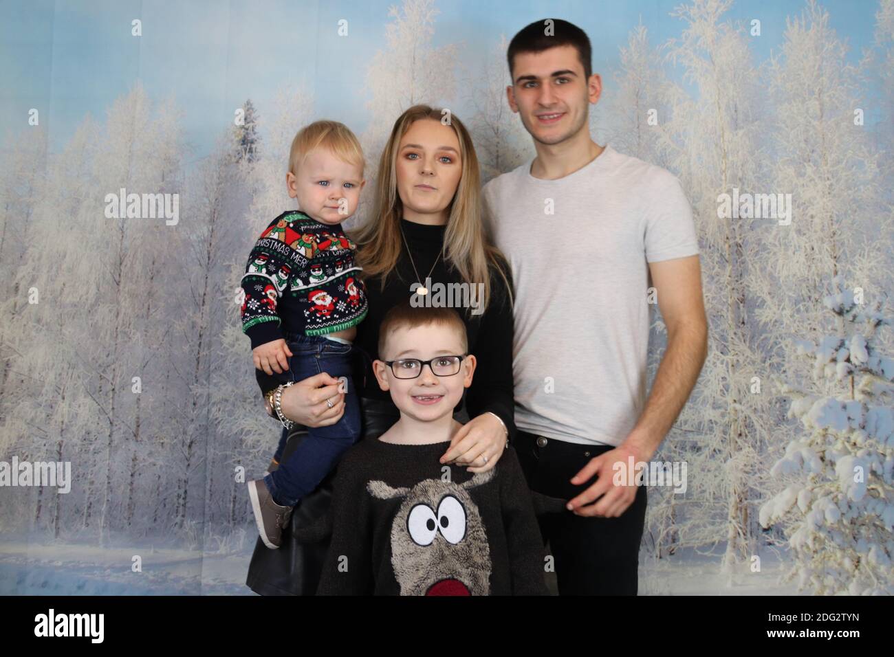 A traditional happy family Christmas photoshoot with a Christmas
