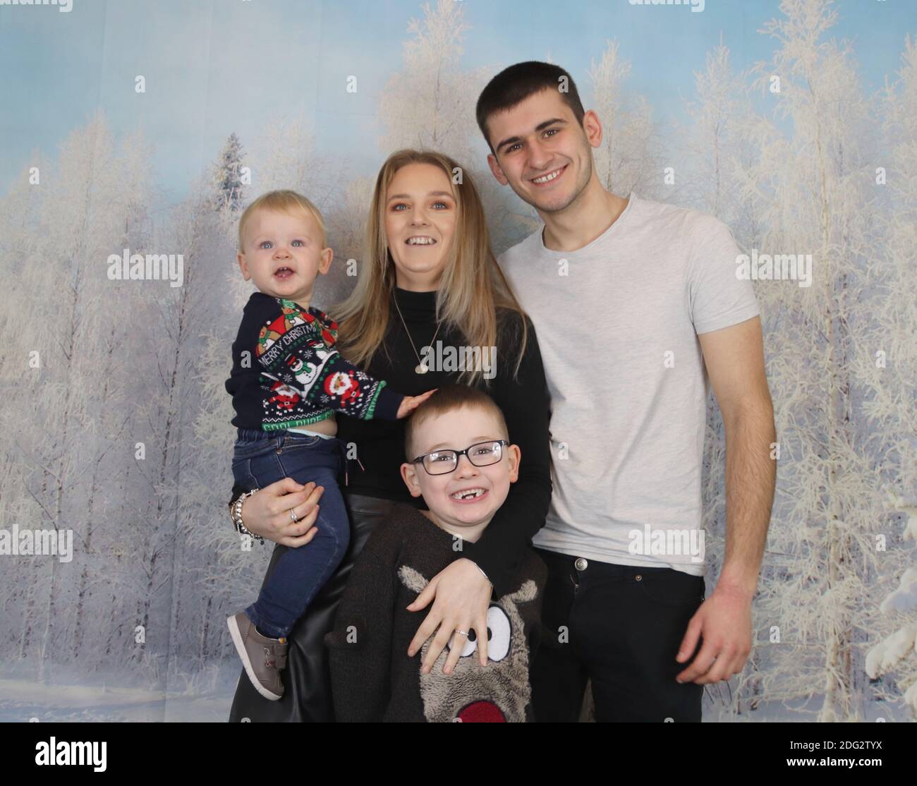 A traditional happy family Christmas photoshoot with a Christmas