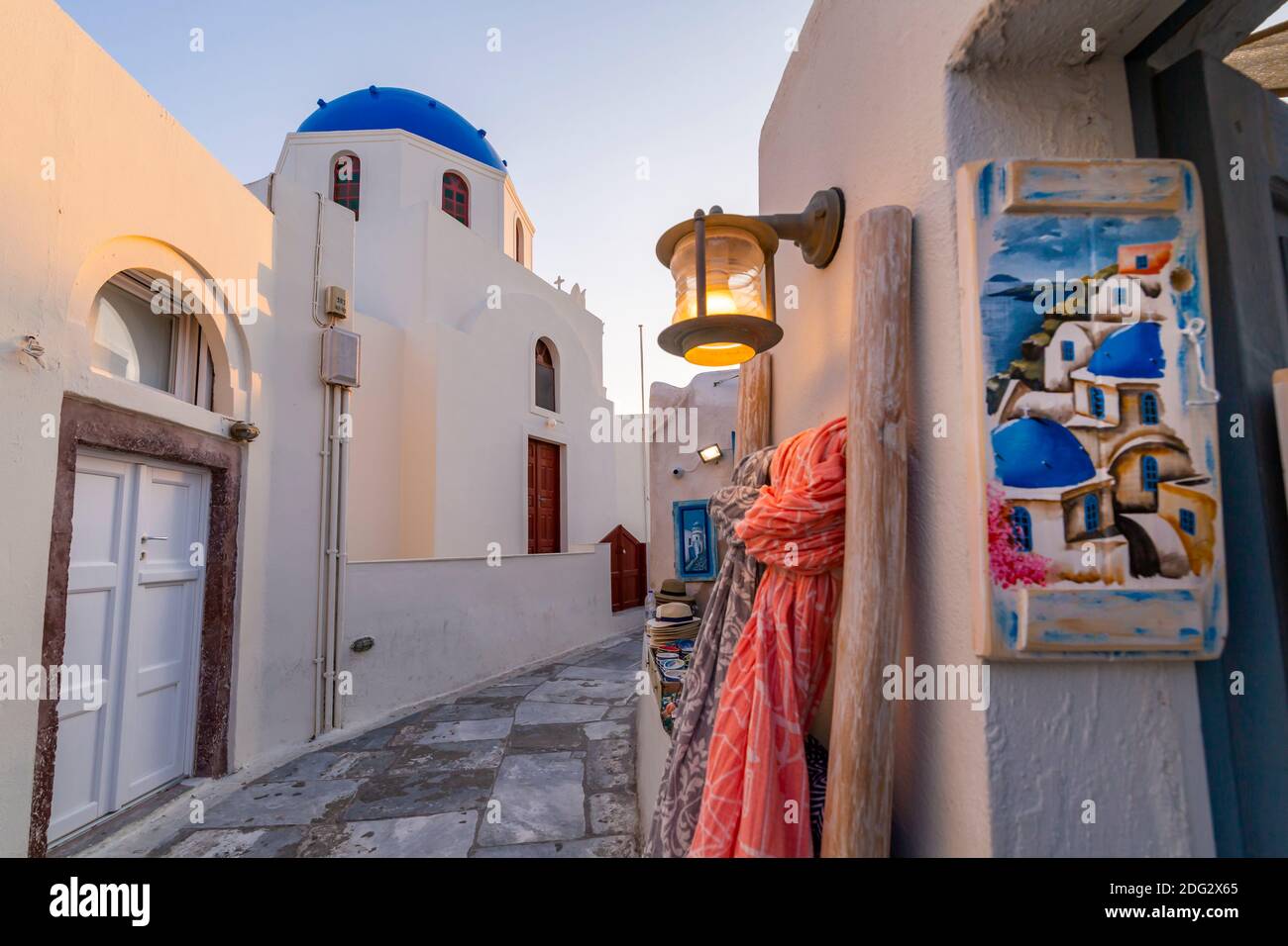 View of church and souvenir painted pictures shop in Oia, Santorini, Greek Islands, Greece, Europe Stock Photo