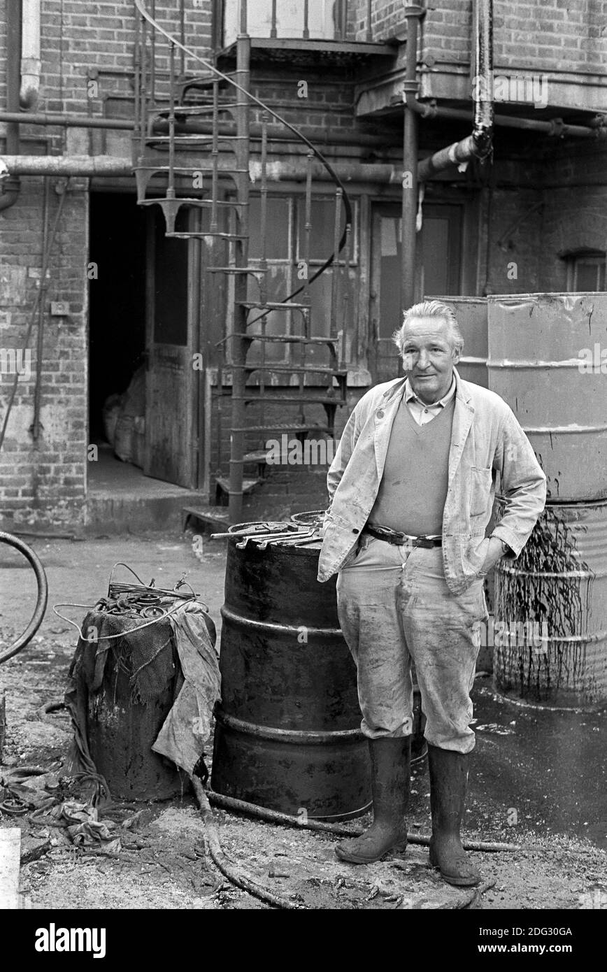 UK, London, Docklands, Isle of Dogs. early 1974. A man working in a factory yard near to Coldharbour. Stock Photo