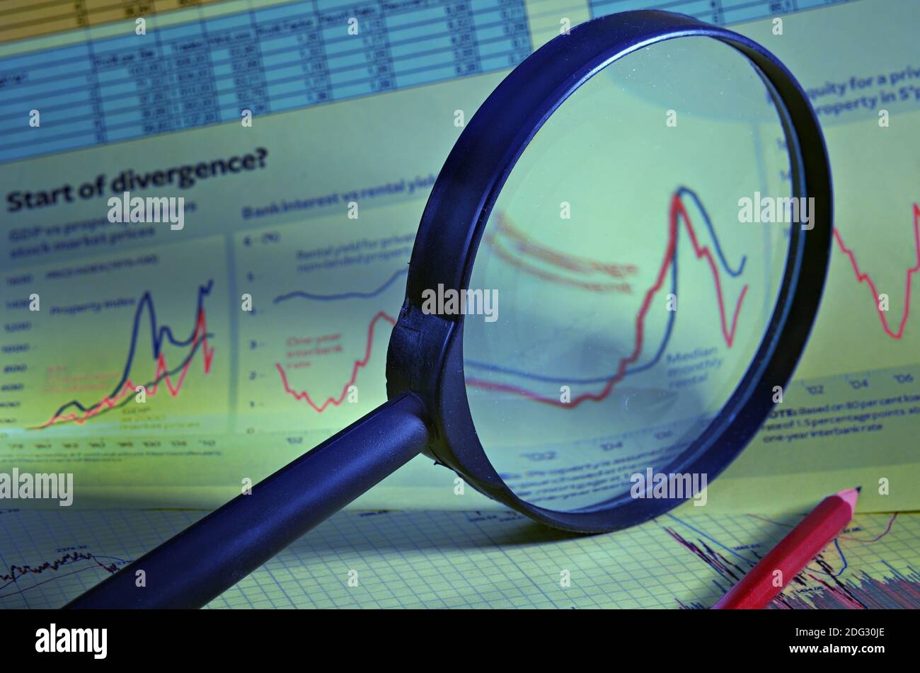 Magnifier against financial schedules and tables of the data Stock Photo