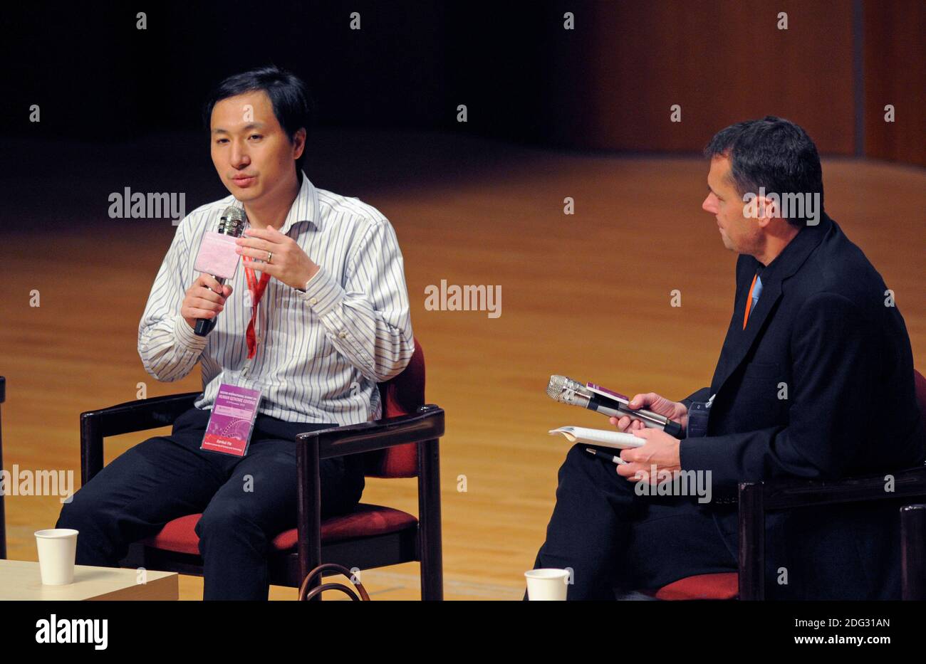 Chinese biologist He Jiankui gives a presentation at Hong Kong University during the Second International Summit on Humane Genome Editing. He had biologically altered the genome of two twins in an attempt to make them resistant to AIDS, which their biological father had. He was condemned by the scientific community, and was taken into custody immediately after his talk and was eventually jailed. At right is Matthew Porteus of Stanford University. Stock Photo