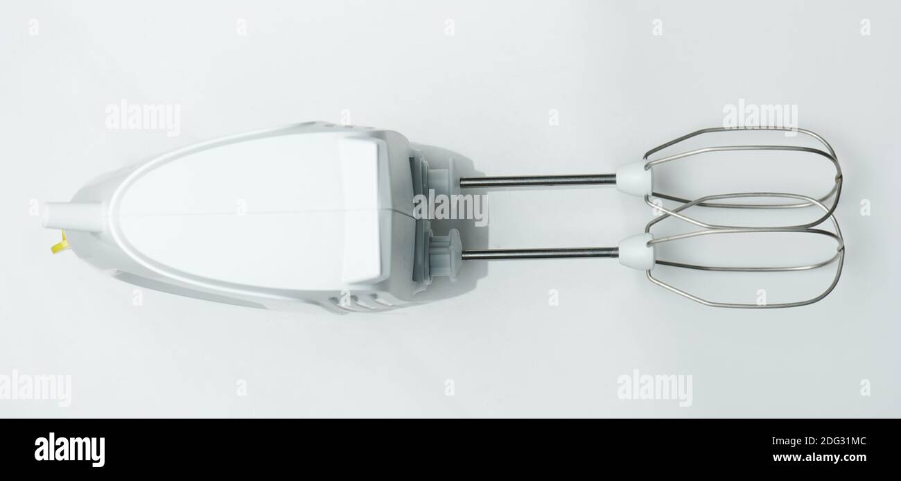 Hand mixer on a white surface. Manual egg beater isolated on white  background Stock Photo - Alamy