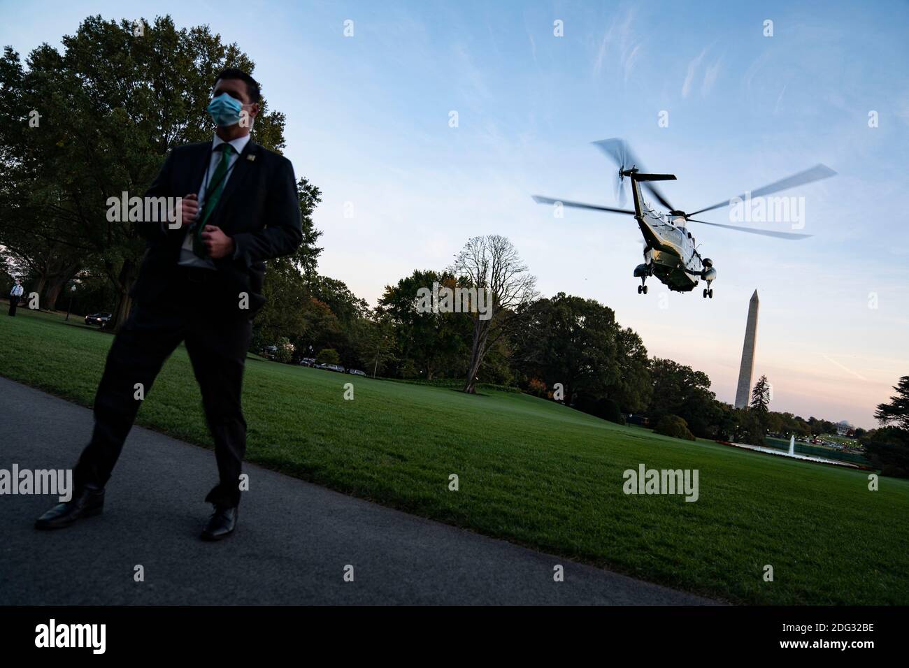 A U.S. Secret Service Agent stands guard as Marine One, carrying U.S. President Donald Trump departs the White House in Washington, DC, USA, 20 October 2020. Trump is scheduled to host a campaign rally in Erie, Pennsylvania before returning to the White House tonight. Credit: Alex Edelman/The Photo Access Stock Photo