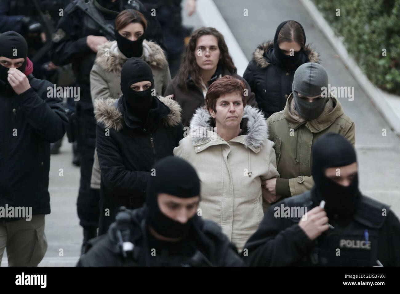 Paula Roupa (C) is escorted by anti-terrorist police officers coming out of  the offices of prosecutors in a court in Athens, on Friday January 6, 2017.  The 48-year-old woman, a member of