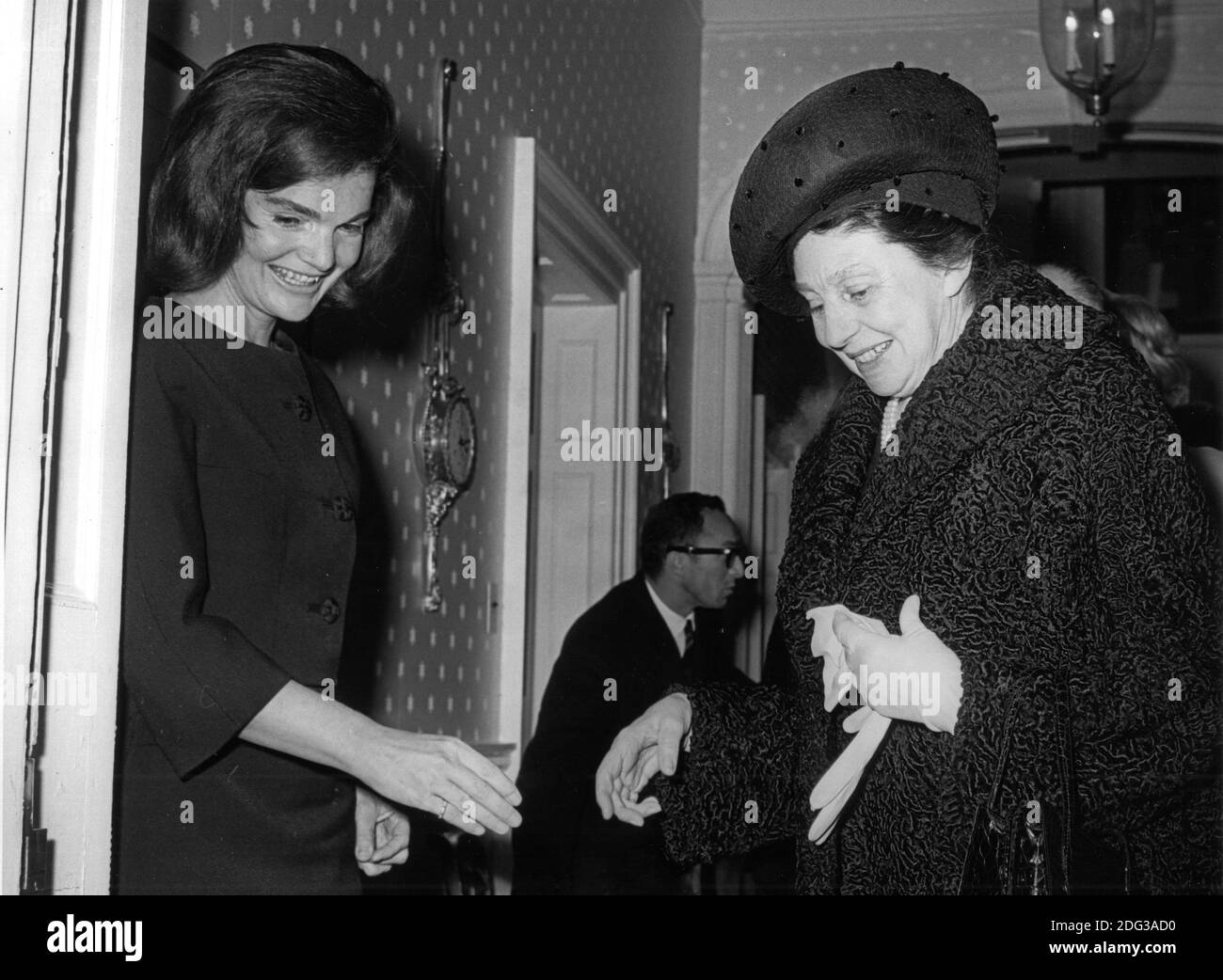 Former first lady Jacqueline Bouvier Kennedy, left, welcomes Laura Carta Camprino, wife of President Antonio Segni of Italy, right, to her Georgetown home in Washington, DC, USA, on January 14, 1964. Mrs. Segni had tea with the former first lady for a half hour while her husband met with United States President Lyndon B. Johnson at the White House. Photo by Benjamin E. 'Gene' Forte / CNP Stock Photo